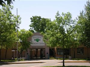 The front entrance of the community center surrounded by trees